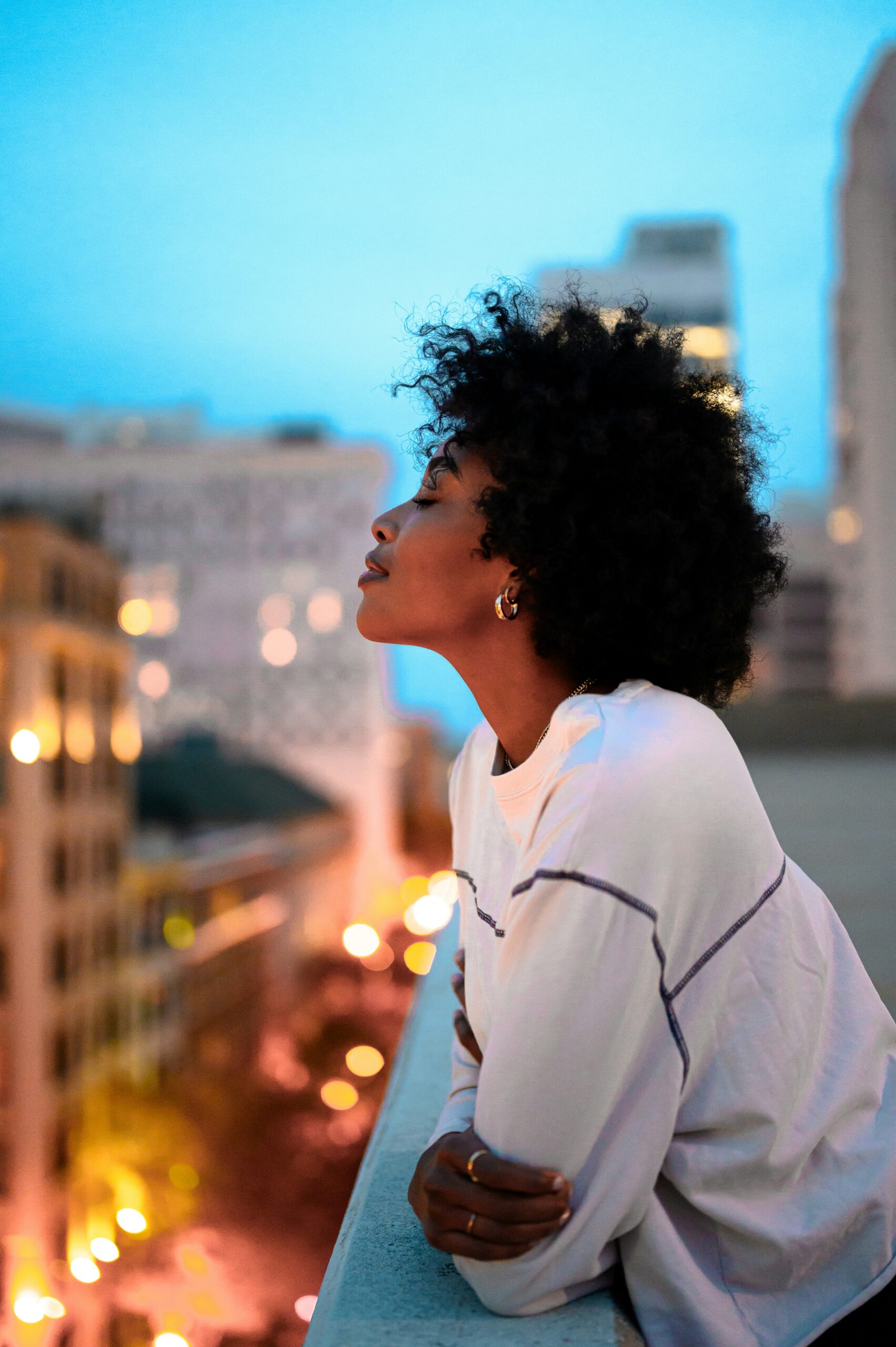 A Black Woman Basking in Peace on a terrace in Madrid.